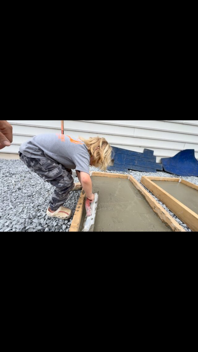 Brecklan trying his hand at concrete finishing, making some samples for stamped concrete with daddy!